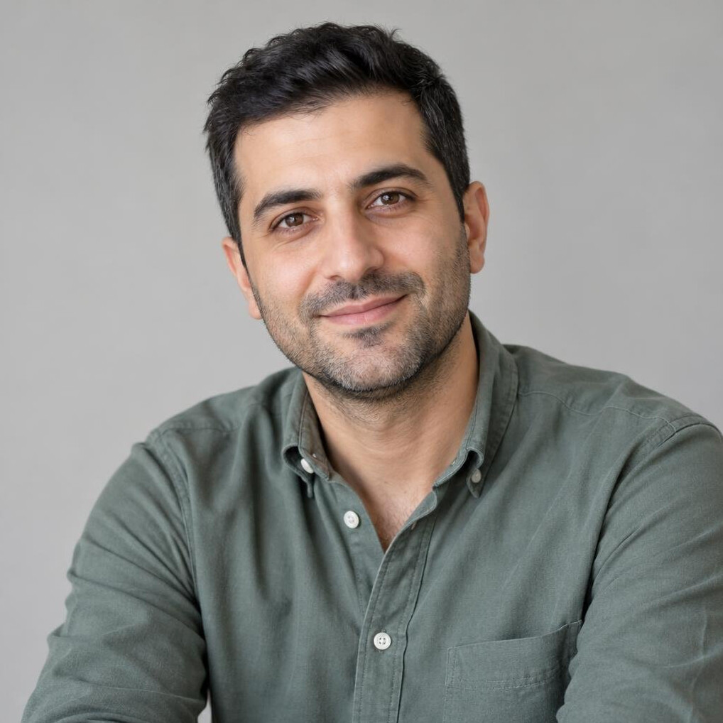 Portrait of a man with short dark hair in a casual shirt